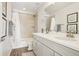 Bathroom featuring double vanity with sink, tiled shower and framed wall art at 5227 Lake Port Ave, Longmont, CO 80504