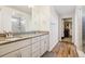 Modern bathroom featuring double vanity with granite countertop, a glass shower, and a walk-in closet at 5227 Lake Port Ave, Longmont, CO 80504