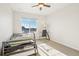 Bright bedroom featuring large window, a bed with trundle, a desk and a chair at 5227 Lake Port Ave, Longmont, CO 80504