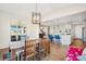 Dining area open to the kitchen with hardwood floors and modern lighting at 5227 Lake Port Ave, Longmont, CO 80504