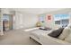 Bright living room featuring white sofa, a coffee table, and large windows at 5227 Lake Port Ave, Longmont, CO 80504