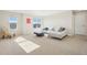 Bright living room featuring white sofa, a coffee table, decorative chair and large windows at 5227 Lake Port Ave, Longmont, CO 80504