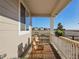 Inviting front porch features a cozy seating area, flower boxes and relaxing outdoor space at 5227 Lake Port Ave, Longmont, CO 80504