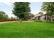 Large grassy backyard, mature trees, and patio offer space for outdoor living and entertaining at 655 Cree Cir, Boulder, CO 80303