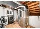 Unfinished basement area with exposed utilities, including a modern washer and dryer at 655 Cree Cir, Boulder, CO 80303