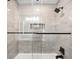 Luxurious bathroom featuring a tiled shower with glass doors and modern fixtures at 655 Cree Cir, Boulder, CO 80303