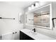 Modern bathroom with a sleek vanity, illuminated mirror, and stylish black fixtures at 655 Cree Cir, Boulder, CO 80303