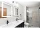 Modern bathroom with dual sinks, sleek fixtures, and a glass-enclosed shower at 655 Cree Cir, Boulder, CO 80303