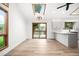 Bright kitchen and dining area featuring wood floors, sliding doors, and a breakfast bar at 655 Cree Cir, Boulder, CO 80303
