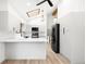 Modern kitchen featuring white cabinetry, stainless steel appliances, and a large island at 655 Cree Cir, Boulder, CO 80303