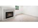 Cozy living room with a fireplace, neutral carpet, and a bright window at 655 Cree Cir, Boulder, CO 80303