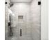 Modern shower with neutral toned marble tiles, and matte black fixtures at 655 Cree Cir, Boulder, CO 80303