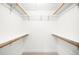 Spacious walk-in closet with built-in shelves and wooden rods for organized storage at 655 Cree Cir, Boulder, CO 80303