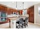 Well-equipped kitchen boasting dark wood cabinets, granite countertops, and a center island at 9550 Firenze Way, Highlands Ranch, CO 80126