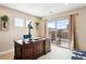 Bright home office with a large desk, natural light, and access to a private balcony at 9550 Firenze Way, Highlands Ranch, CO 80126