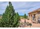 Community pool area showcasing lush greenery, a stone building, and inviting outdoor spaces with scenic views at 9550 Firenze Way, Highlands Ranch, CO 80126