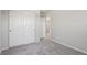 Bedroom includes a closet with sliding doors, neutral walls, and plush carpeting at 7245 Goldbloom Ln, Littleton, CO 80125