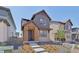 Charming two-story home with stone facade, landscaped yard, and inviting entrance at 7245 Goldbloom Ln, Littleton, CO 80125