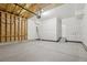 This spacious garage features concrete flooring, an automatic door, and is ready for personalization and finishing at 7245 Goldbloom Ln, Littleton, CO 80125
