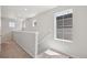 Hallway with neutral walls, plush carpet, and natural light from large double-paned windows at 7245 Goldbloom Ln, Littleton, CO 80125