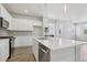Modern kitchen featuring white cabinets, quartz countertops, and stainless steel appliances at 7245 Goldbloom Ln, Littleton, CO 80125