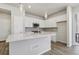 Modern kitchen with white cabinets, stainless steel appliances, and a stylish island at 7245 Goldbloom Ln, Littleton, CO 80125