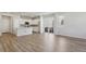 Bright open-concept living area featuring a modern kitchen with white cabinets and an island at 7245 Goldbloom Ln, Littleton, CO 80125