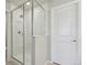 Bright bathroom features a tile surround glass shower and white interior door at 7245 Goldbloom Ln, Littleton, CO 80125