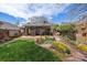 Lush backyard with garden, patio, and sunroom, perfect for outdoor relaxation and entertainment at 1572 Leyden St, Denver, CO 80220