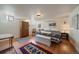 Cozy bedroom with hardwood floors, a wooden wardrobe, and a comfortable bed with colorful linens at 1572 Leyden St, Denver, CO 80220