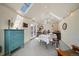 Bright dining area with white-painted brick walls, skylights, and access to the outdoors at 1572 Leyden St, Denver, CO 80220