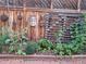 Vegetable garden along a wooden fence with decorative elements at 1572 Leyden St, Denver, CO 80220