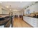 Bright kitchen with white cabinetry, stainless steel appliances, and hardwood floors at 1572 Leyden St, Denver, CO 80220