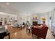 Bright living room with hardwood floors and a cozy fireplace open to the kitchen at 1572 Leyden St, Denver, CO 80220