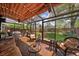 Bright sunroom with glass ceiling, tiled floor, and comfortable seating overlooking the landscaped backyard at 1572 Leyden St, Denver, CO 80220