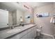 Bright bathroom with double sinks, a large mirror, and a shower with glass doors at 3378 Shoveler Trl, Castle Rock, CO 80104