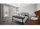 Neutral bedroom featuring windows on two sides, gray carpet, and a ceiling fan at 3378 Shoveler Trl, Castle Rock, CO 80104