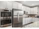 Close up on kitchen with stainless steel appliances, white cabinets, and granite countertops at 3378 Shoveler Trl, Castle Rock, CO 80104