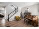 Bright living room featuring beautiful hardwood floors, staircase, and an elegant piano at 3378 Shoveler Trl, Castle Rock, CO 80104