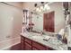 Bathroom featuring granite vanity, tub with shower, and decorative accents at 748 Ridgeside Dr, Golden, CO 80401