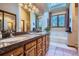 Bright bathroom with double sinks, granite countertop, and natural light at 748 Ridgeside Dr, Golden, CO 80401