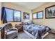 A serene bedroom features a comfortable queen bed, soft lighting, and scenic window views at 748 Ridgeside Dr, Golden, CO 80401