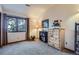 Cozy bedroom with natural light, soft carpet, and a dresser with decorative flowers at 748 Ridgeside Dr, Golden, CO 80401