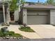 Inviting townhome exterior with a two-car garage, pathway, and mature aspen trees adding curb appeal at 748 Ridgeside Dr, Golden, CO 80401