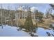 Multi-story condo with wintery landscape, mature trees, and patches of snow at 748 Ridgeside Dr, Golden, CO 80401