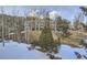 Exterior view of a condo community surrounded by trees and a snowy ground cover at 748 Ridgeside Dr, Golden, CO 80401