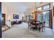 Open-concept living area featuring a dining table, fireplace, and large windows with natural light at 748 Ridgeside Dr, Golden, CO 80401