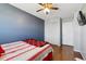 This well-lit bedroom offers ample closet space, complemented by wood floors and a ceiling fan at 1009 Milky Way, Thornton, CO 80260