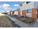 View of the townhomes and their front yards, showcasing a community-oriented layout at 1009 Milky Way, Thornton, CO 80260