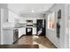 Bright kitchen with white cabinets, black appliances, and stylish tile floors under natural light at 1009 Milky Way, Thornton, CO 80260